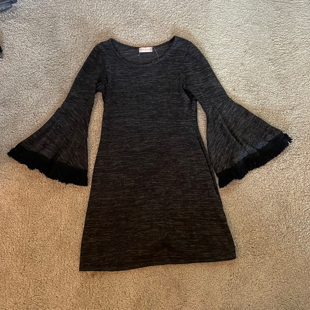 Sweater dress. Form fitting at the top, flowy sleeves and at the bottom.